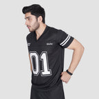 Man wearing a black sports jersey with '01' on a light gray background