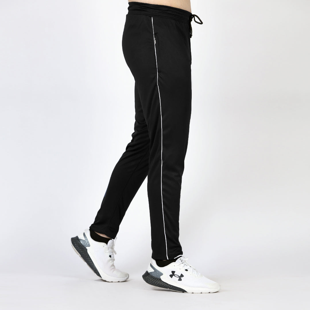 Black pants with white stripes worn by a person on a white background