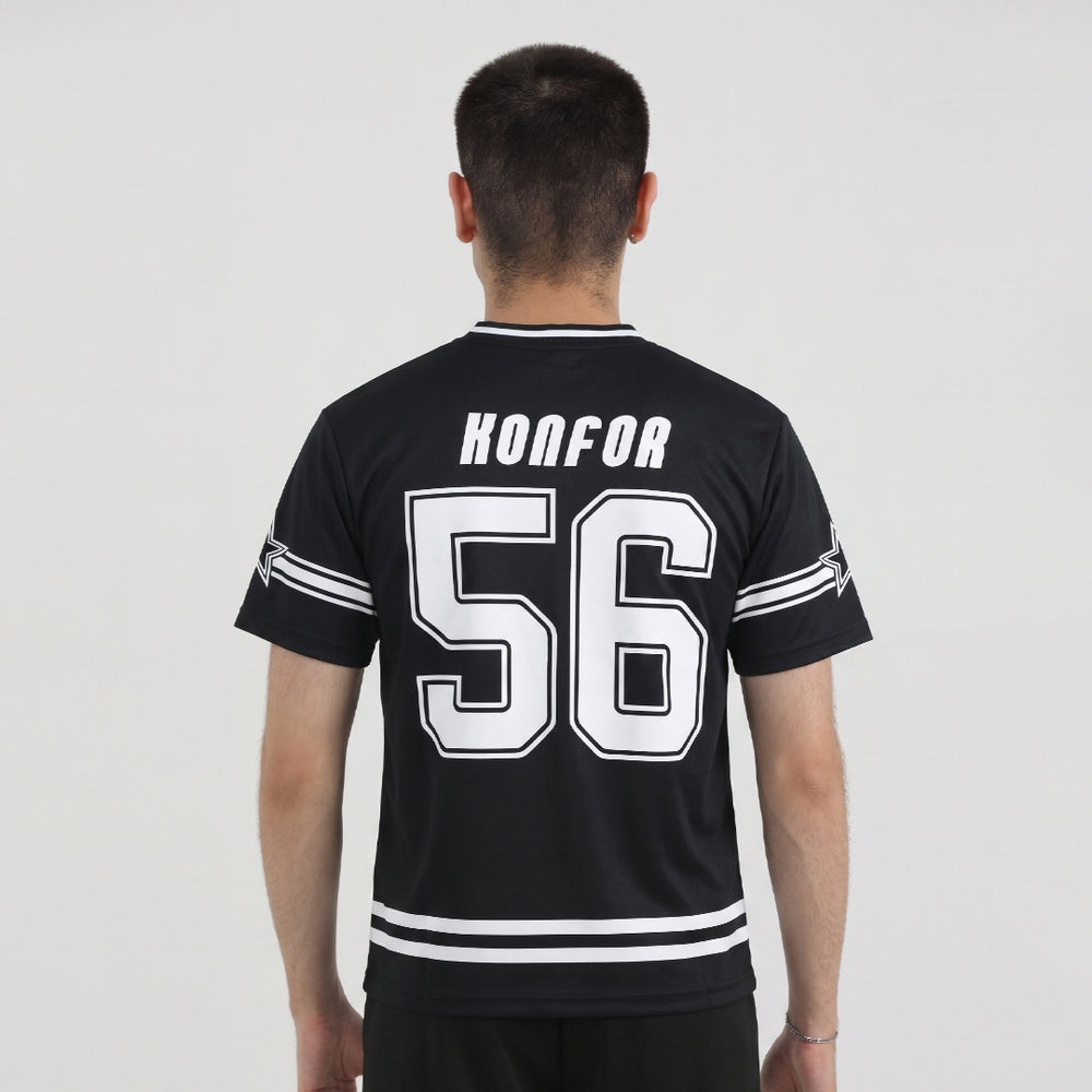Person wearing a black sports jersey with white lettering and numbers on a plain background