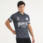 Man wearing a dark gray polo shirt with white text and accents on a light gray background