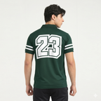 Person wearing a green polo shirt with the number 23 on the back against a white background