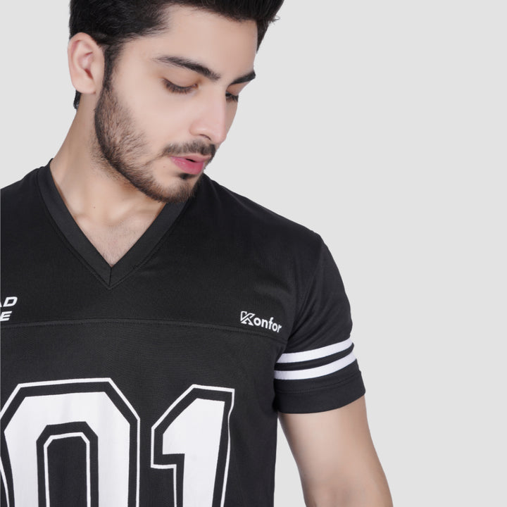 Man wearing a black sports jersey with white lettering on a plain background