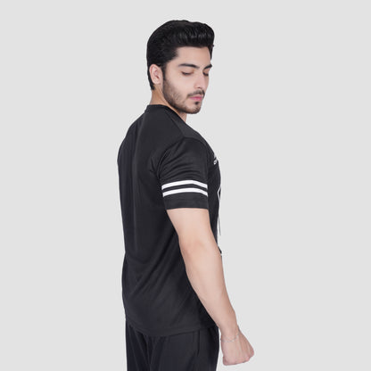 Man wearing a black sports outfit with white stripes on a light gray background