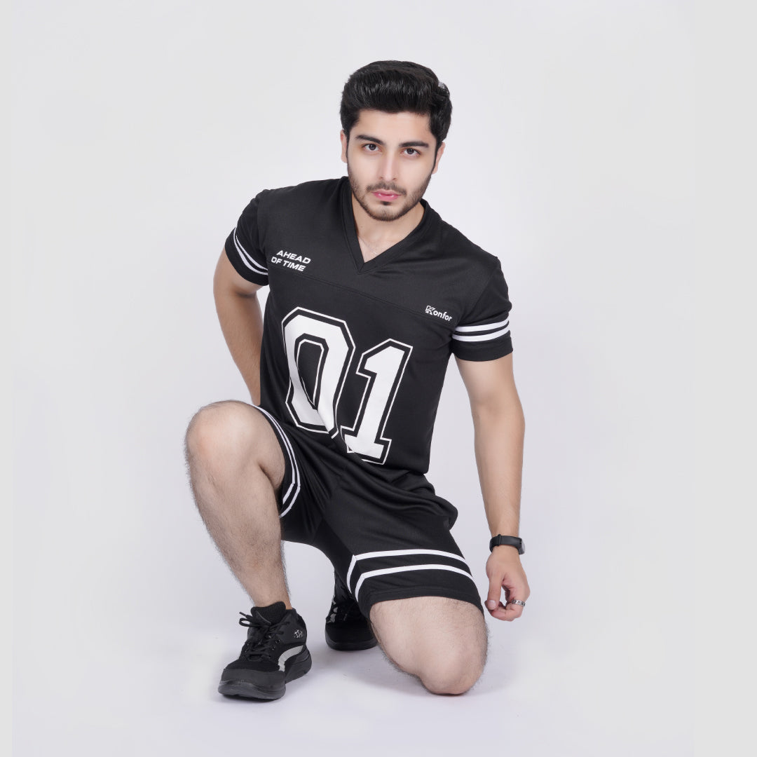 Man wearing a black sports outfit with white text and numbers on a white background