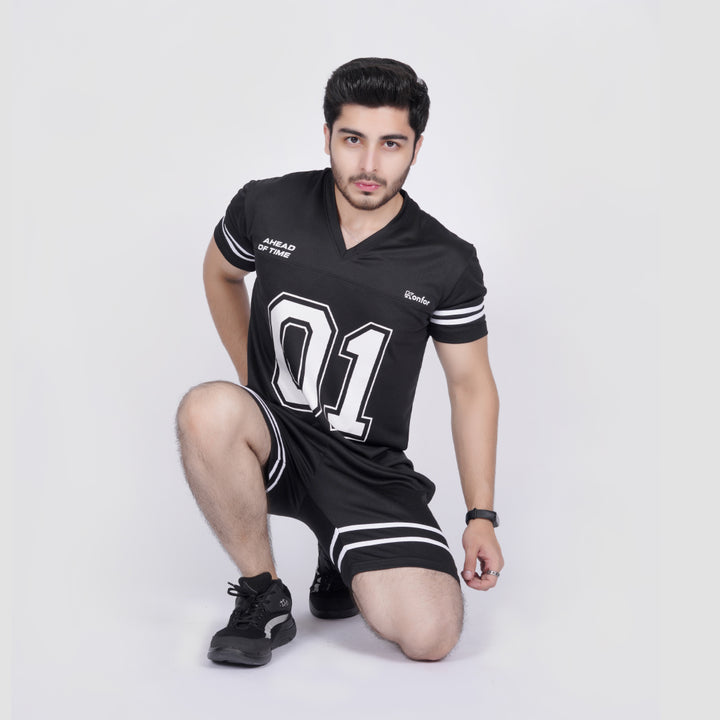 Man wearing a black sports outfit with white text and numbers on a white background