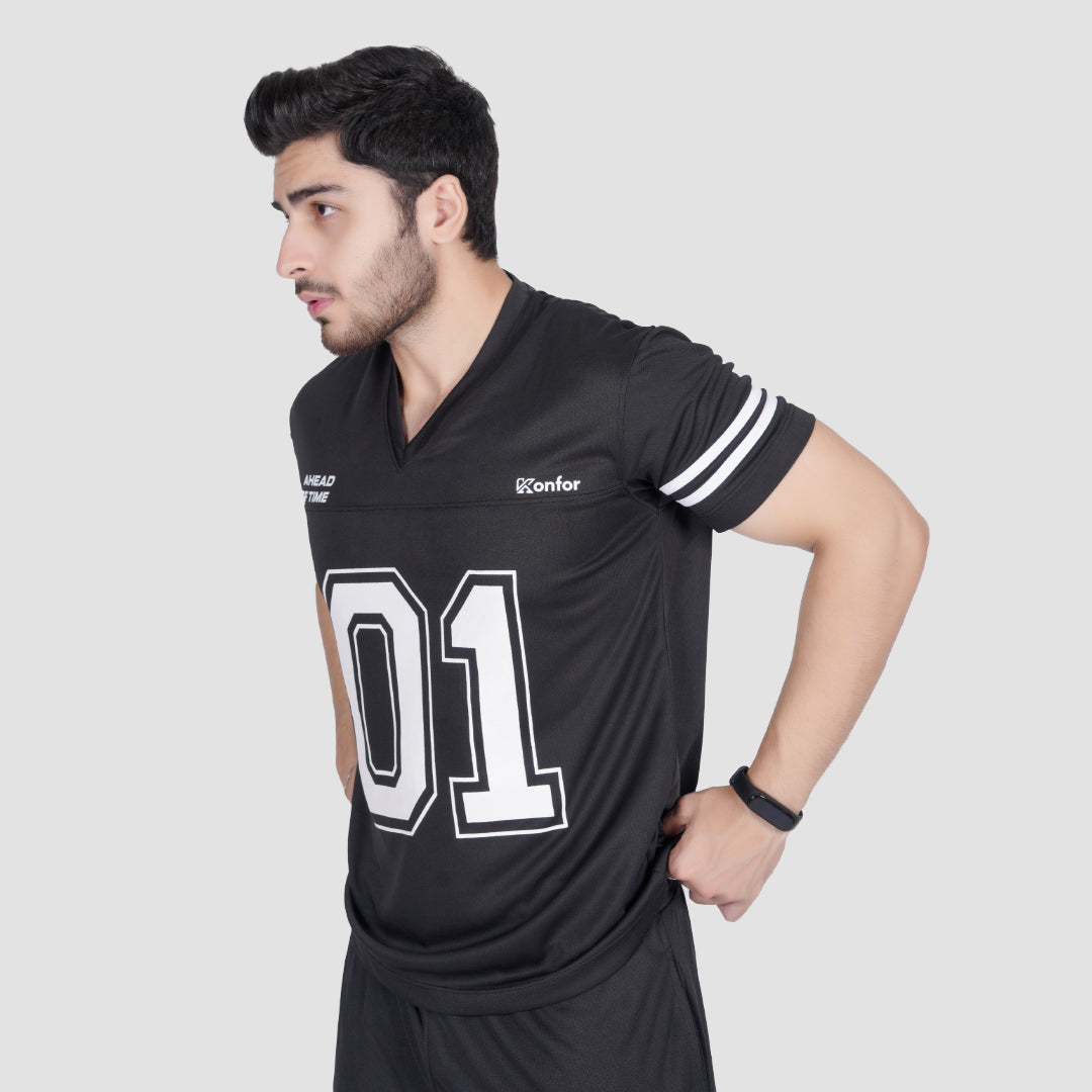 Man wearing a black sports jersey with '01' on a light gray background