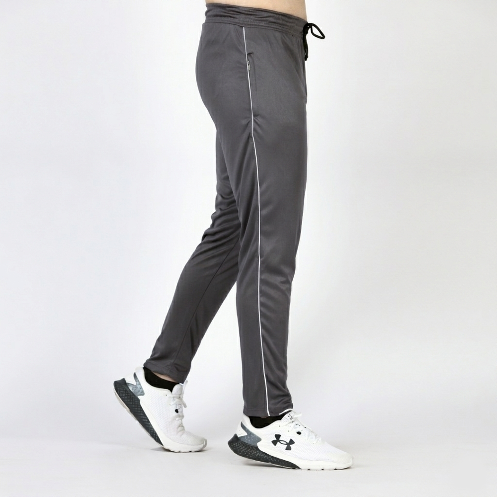 Gray athletic pants with white stripes worn by a person on a white background