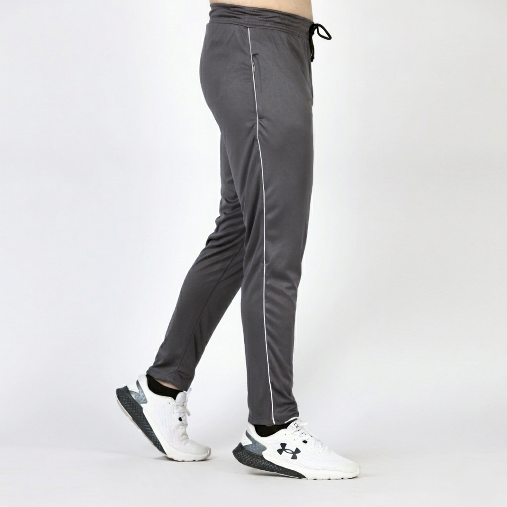 Gray athletic pants with white stripes worn by a person on a white background