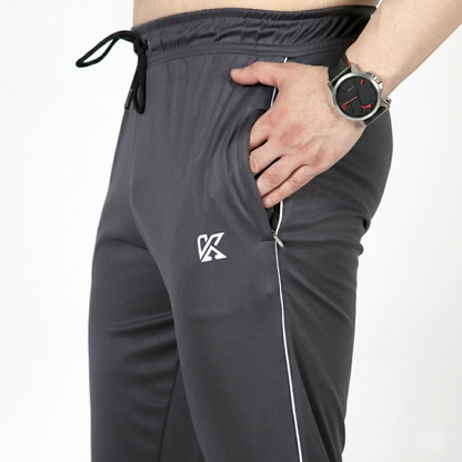 Gray tracksuit pants with a logo on a white background