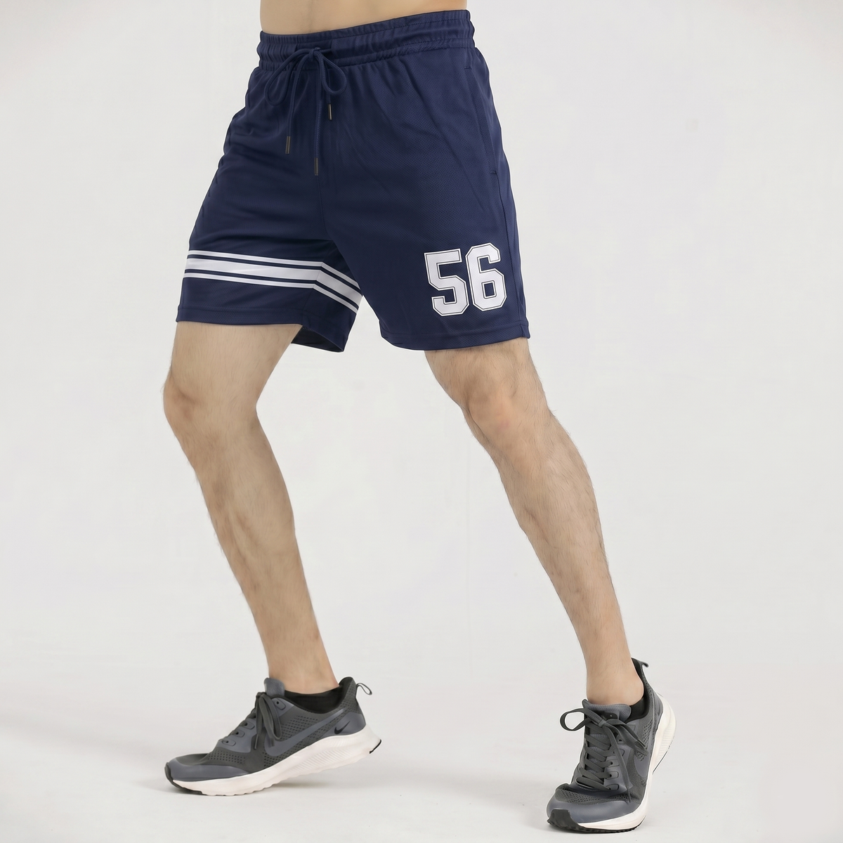 Navy shorts with white stripes and number 56 worn by a person on a white background