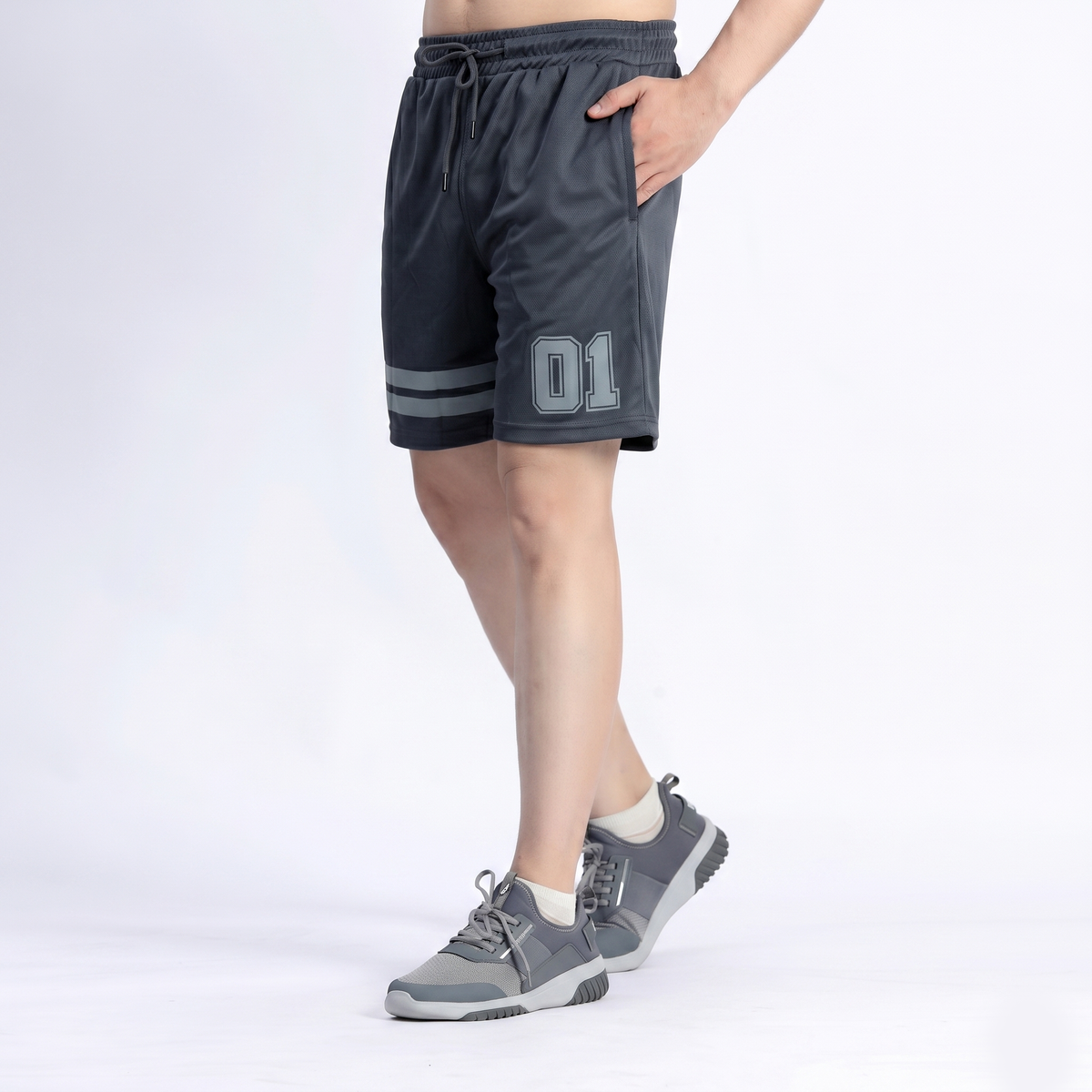 Person wearing gray athletic shorts with a number '01' on a white background