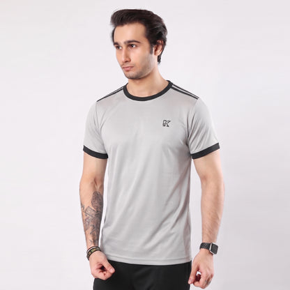 Man wearing a gray t-shirt with black accents on a white background