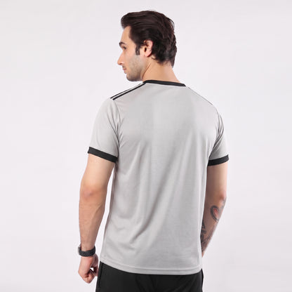 Man wearing a gray t-shirt with black trim on a white background