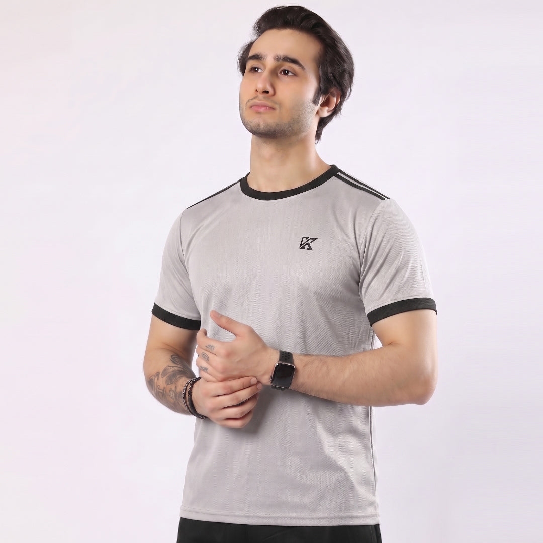 Man wearing a gray t-shirt with black accents on a white background