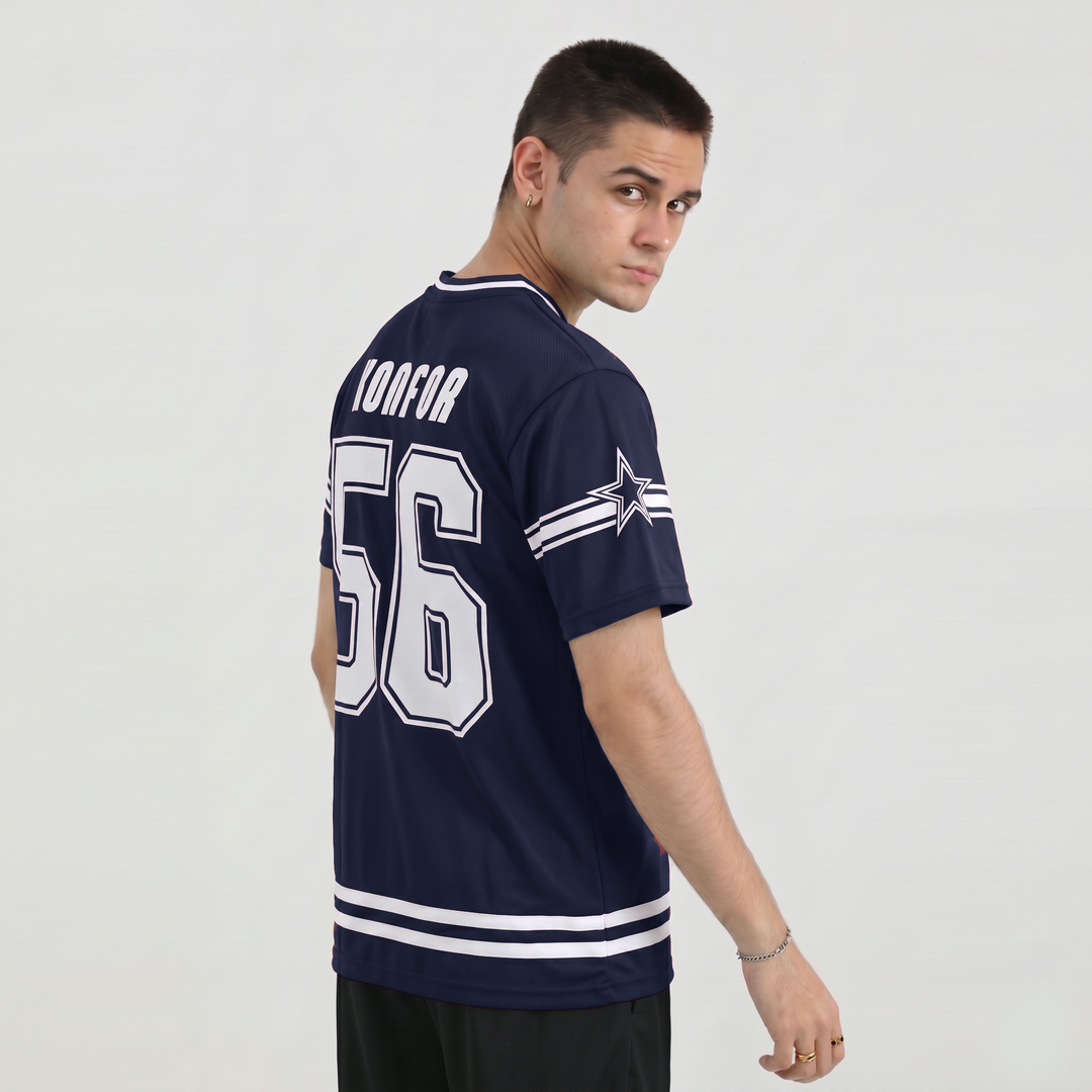 Man wearing a navy blue sports jersey with white lettering and numbering on a plain background