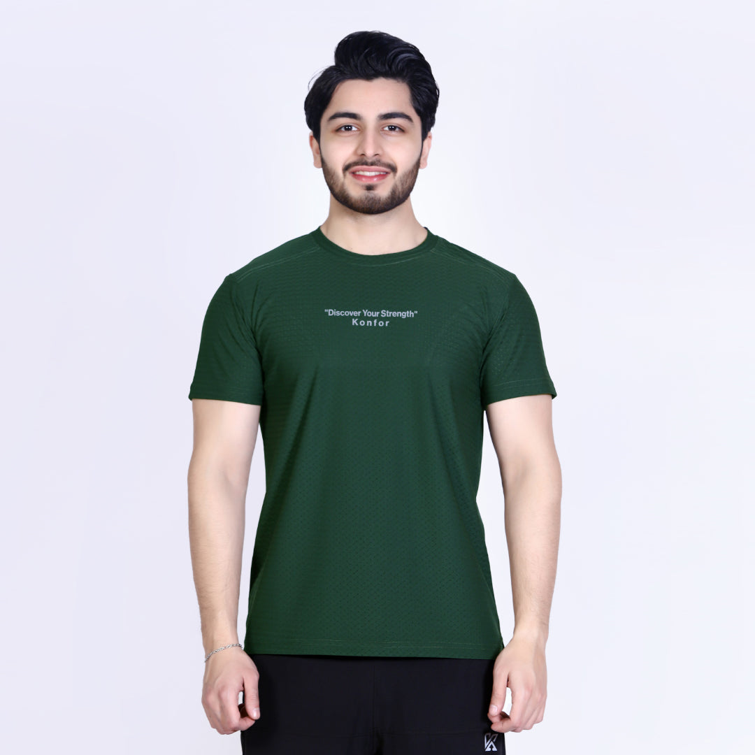 Man wearing a green t-shirt with text on a white background