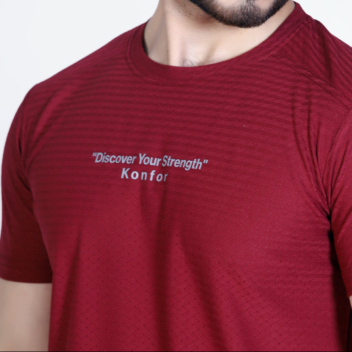 Man wearing a red t-shirt with text on a plain background