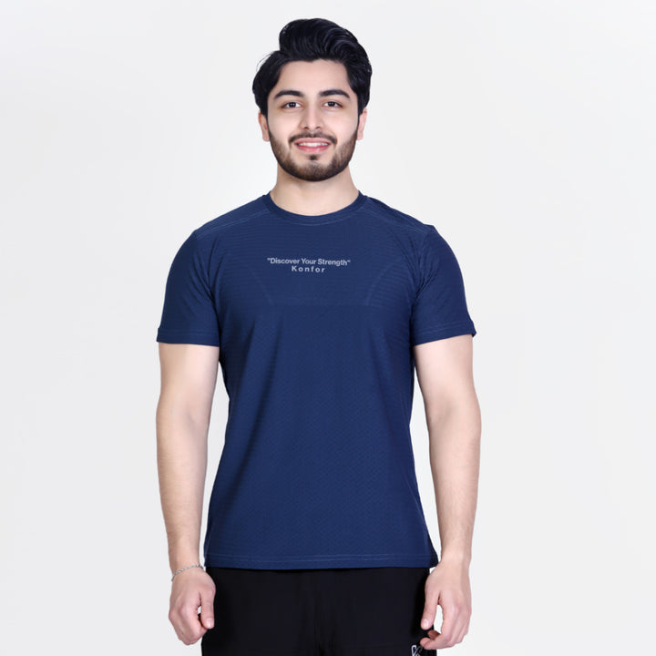 Man wearing a navy blue t-shirt with text on a white background