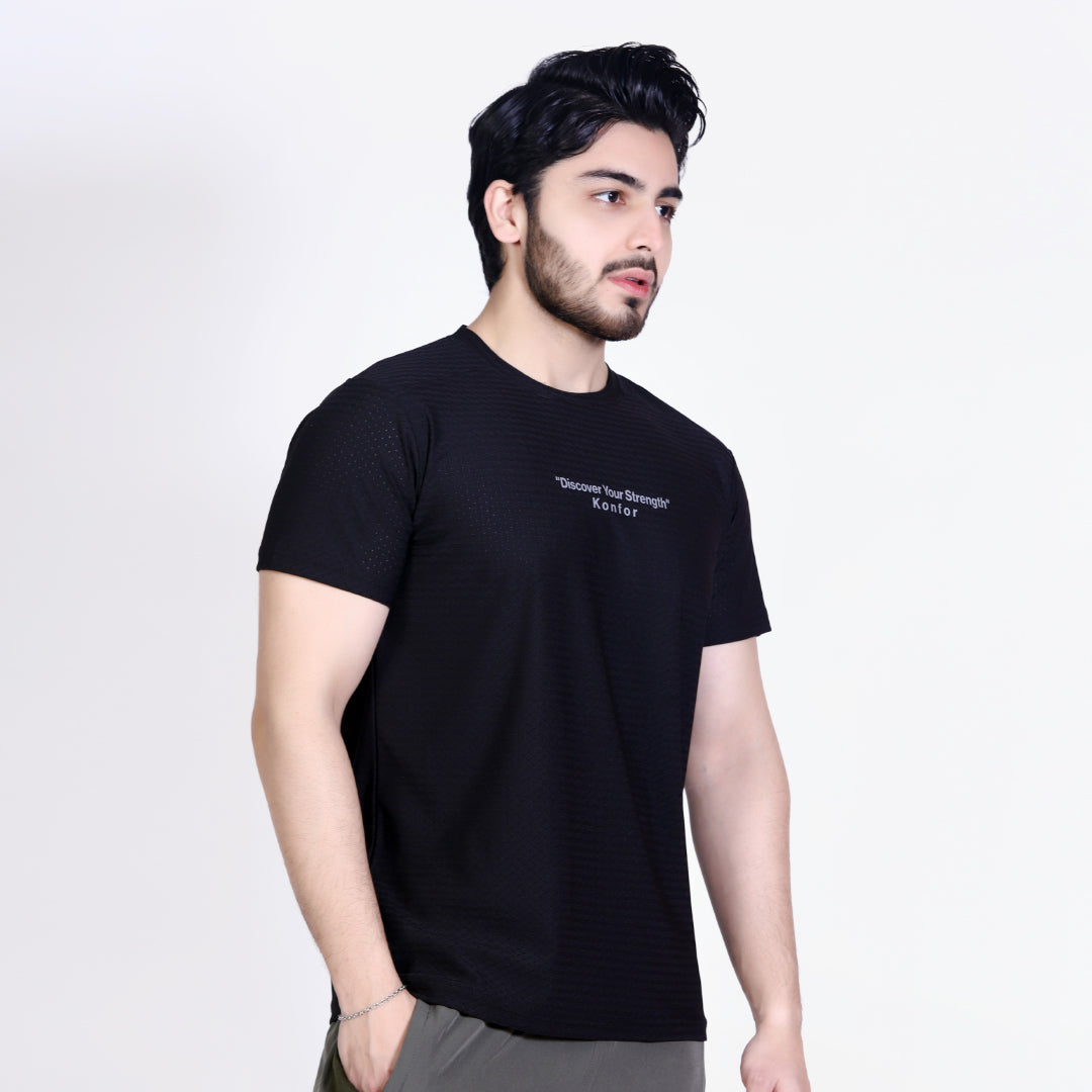 Man wearing a black t-shirt with text on a white background