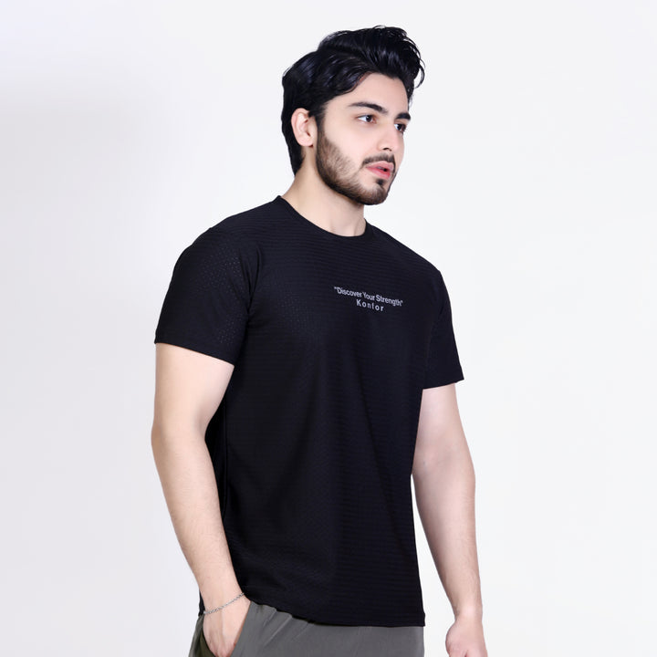 Man wearing a black t-shirt with text on a white background