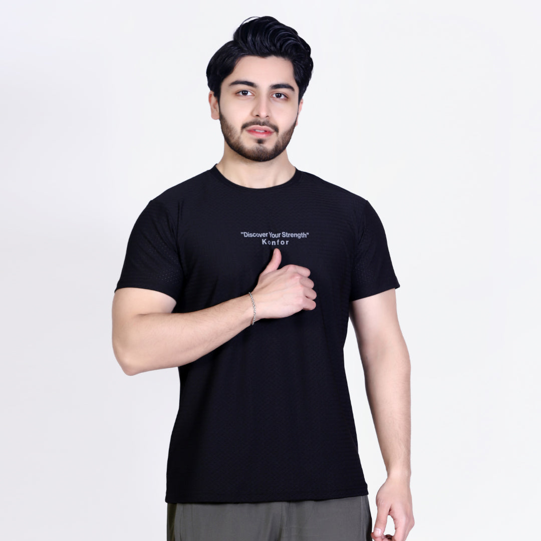 Man wearing a black t-shirt with text on a plain background
