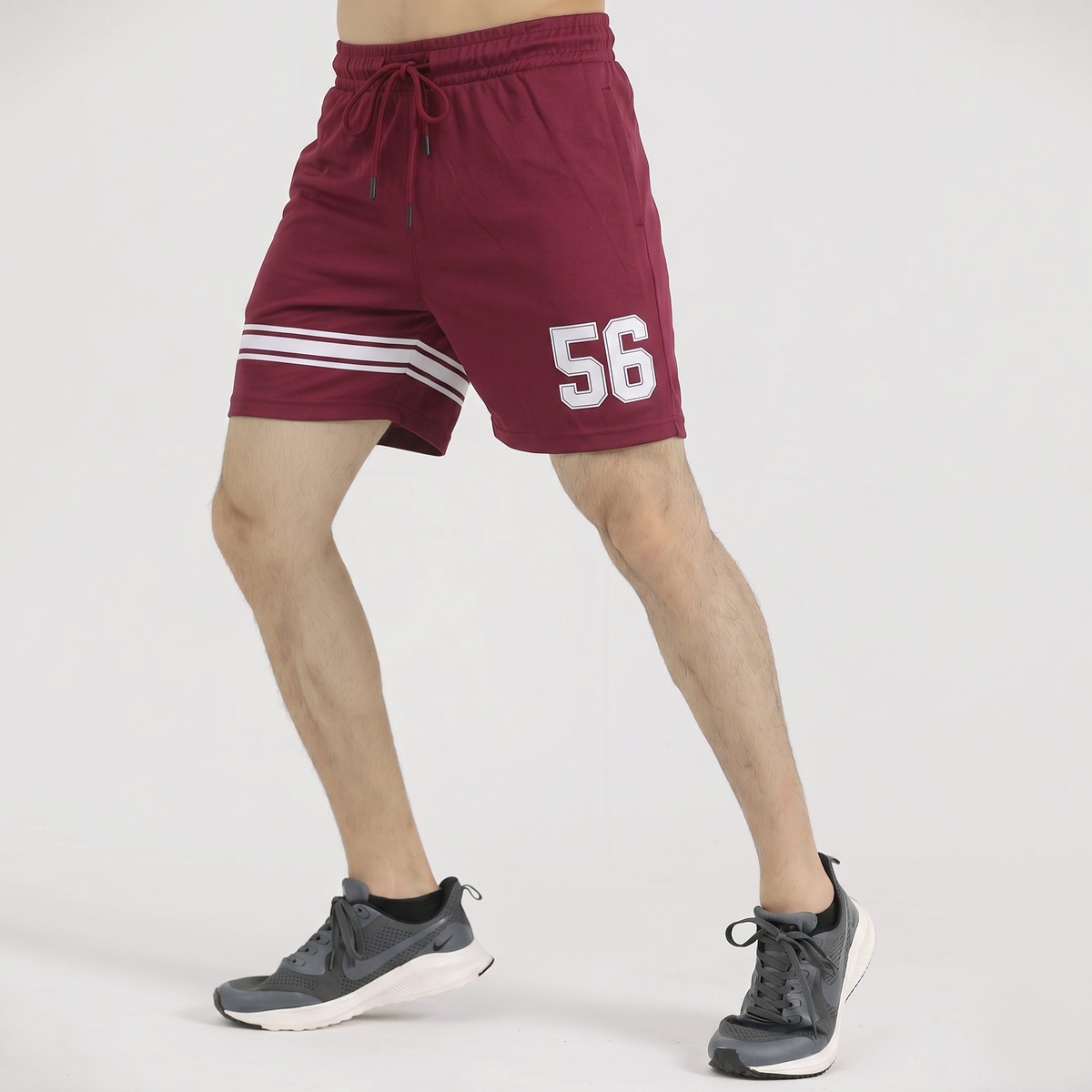 Maroon shorts with number 56 and white stripes on a white background